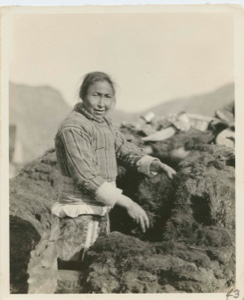 Image of Eskimo [Kalaallit] woman banking house with sod